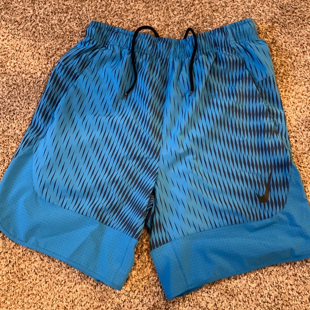 Nike blue running shorts size medium with pockets. Used, good condition.